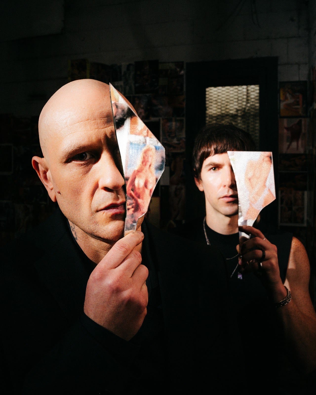 Leo Ashline and Shaun Ringsmuth stand holding magazine page cutouts over half their faces